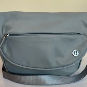 lululemon crossbody bag in light gray nylon with multiple pockets. Lightly used.